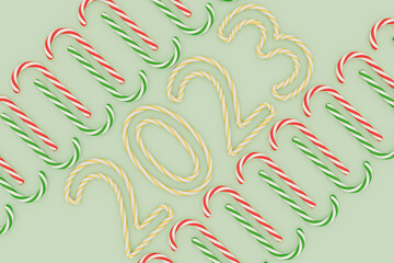 Obraz premium Colorful candy canes on mint green background with 2023 numbers. Holiday 3d render. Christmas and New Year greeting card. Top view. 