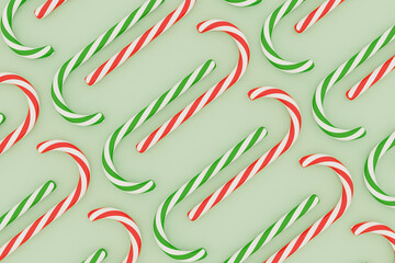 Colorful candy canes on mint green background. Holiday 3d render. Christmas and New Year pattern. Top view.