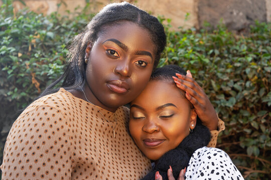 Black sisters holding each other 