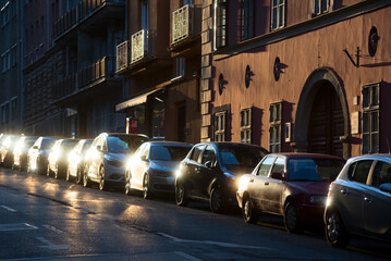 Cars parked in line along old city street
