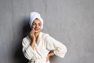 Young healthy serene woman girl relaxing in bathrobe and spa towel after having bath shower at home.