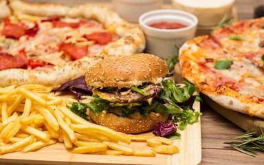 Pizza and hamburger on wooden background