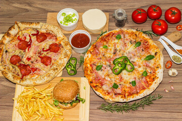 Pizza and hamburger on wooden background