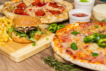 Pizza and hamburger on wooden background