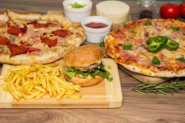 Pizza and hamburger on wooden background
