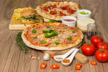 Pizza and hamburger on wooden background