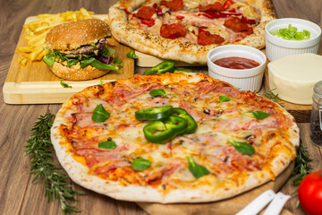 Pizza and hamburger on wooden background