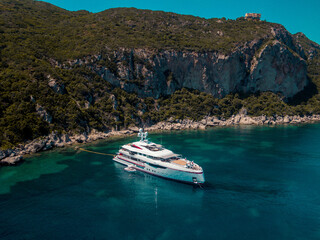Aerial drone view of  luxury private yacht anchored on porto timoni beach in corfu