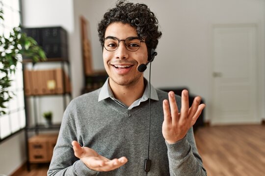 Young Hispanic Call Center Agent Man Smiling Happy Working At The Office.