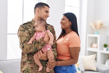 Hispanic family army soldier hugging each other at home