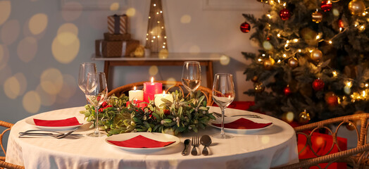 Beautiful table setting for Christmas dinner at home in evening