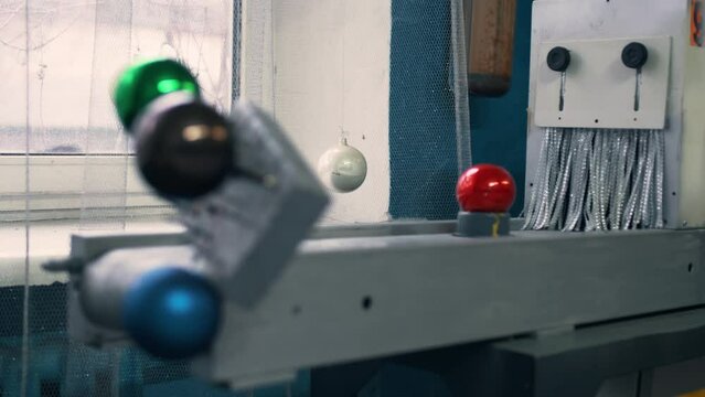 A Christmas tree ball after painting on an automated conveyor line at a factory