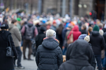 many unrecognizable protesters gathered in the street