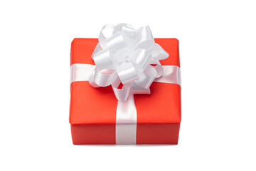 Close up shot of gift box wrapped in red paper and decorated with satin ribbon bow, isolated on white background