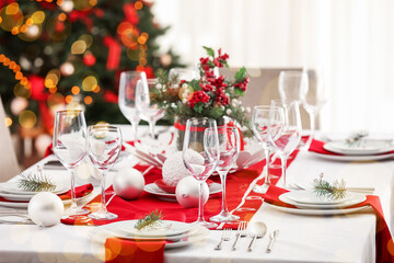 Beautiful table setting for Christmas dinner in living room