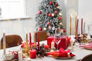 Romantic table setting for Christmas dinner in living room