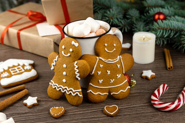 Gingerbread man and gingerbread woman on the background of Christmas decorations.