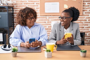 African american women business workers using smartphone working at office