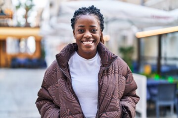 Fototapeta premium African american woman smiling confident standing at coffee shop terrace