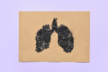 Paper with lungs made of coal on lilac background