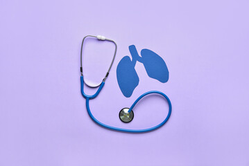 Blue paper lungs with stethoscope on lilac background