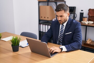 Young hispanic man business worker using laptop working at office