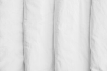 Obraz premium Closeup view of white folded bedding