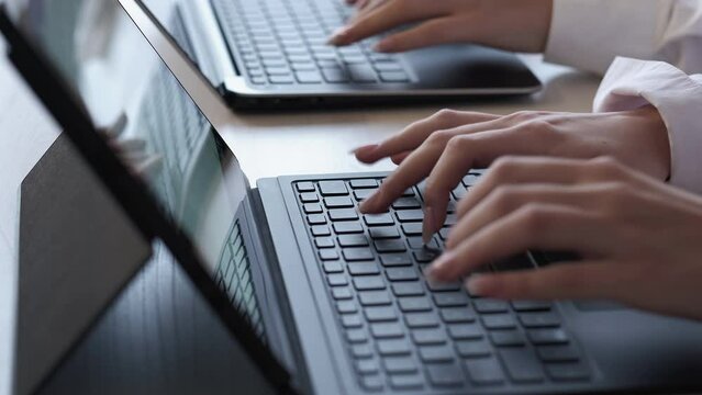 Digital business. Internet marketing. Professional copywriting. Unrecognizable female employees working hands typing web content on laptop keyboard at office workplace.