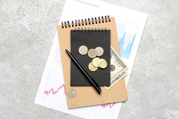 Obraz premium Notebooks with money and diagrams on grunge background. Budget concept