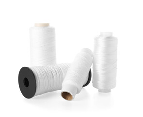 Different sewing thread spools isolated on white background