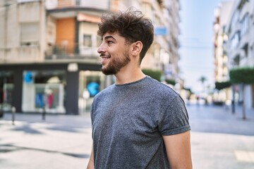 Young arab man smiling happy standing at the city.