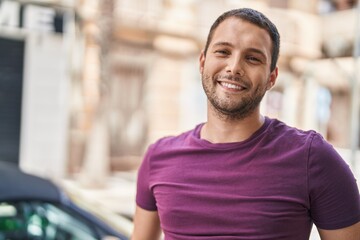 Fototapeta premium Young man smiling confident standing at street