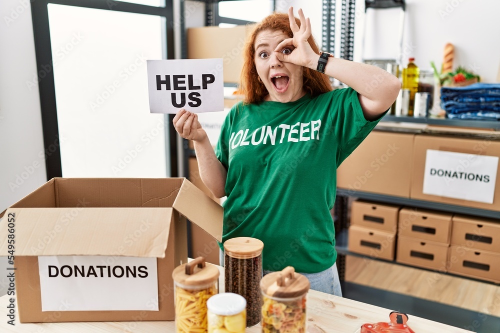 Sticker Young redhead woman wearing volunteer t shirt holding help us banner smiling happy doing ok sign with hand on eye looking through fingers