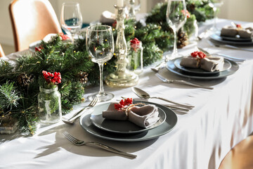 Christmas table setting with fir branches and rowan in dining room