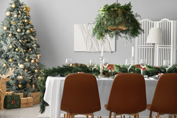 Christmas table setting with fir branches and rowan in dining room