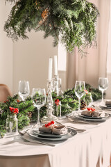 Christmas table setting with fir branches and rowan in dining room