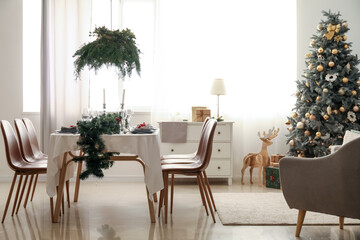 Interior of dining room with table and Christmas tree