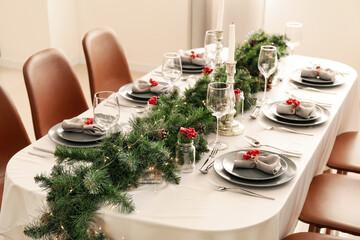 Christmas table setting with fir branches and rowan in dining room