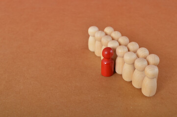 Red leader businessman with crowd of wooden figures. Leadership, cooperation, teamwork, brainstorming, business, team, teamwork and human resource management concept