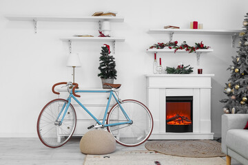 Obraz premium Interior of living room with Christmas tree, fireplace and bicycle