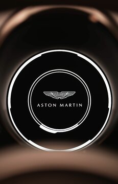 Closeup of an Aston Martin Vantage digital gauge cluster with the Aston Martin logo on it