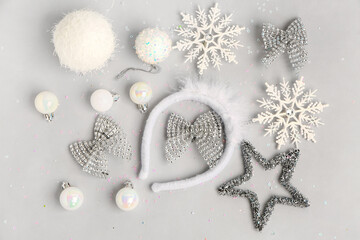 Composition with Christmas headband and decorations on grey background