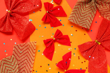 Different Christmas bows and sequins on color background