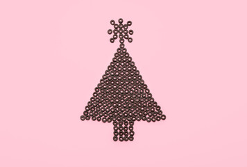 Christmas tree made of cereal rings on pink background
