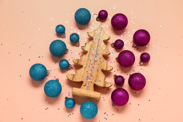 Composition with Christmas balls and wooden decor on color background