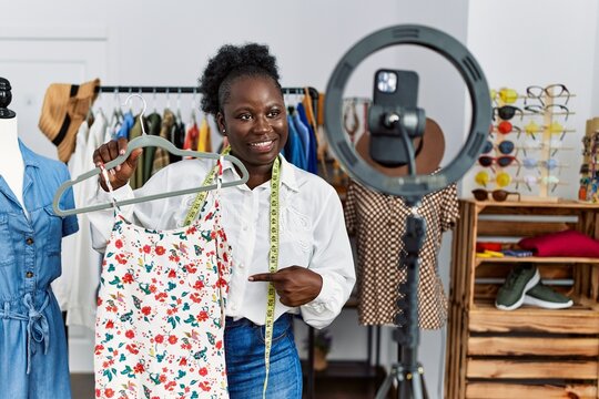 Young African American Woman Shopkeeper Selling Clothes Online At Clothing Store