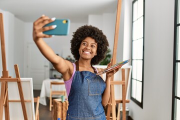 Young african american woman smiling confident make selfie by the smartphone at art studio