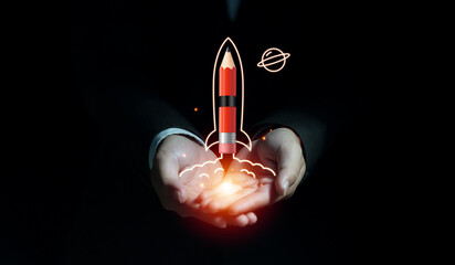 Businessman hand showing rocket pencil launching and flying to space on dark background, Startup...