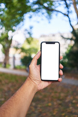 Man holding smartphone showing white blank screen at park