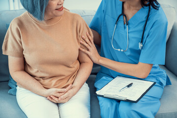 A young caregiver spending time together with a contented senior woman at home. Caregiver being supportive to her patient, Senior nursing at home.